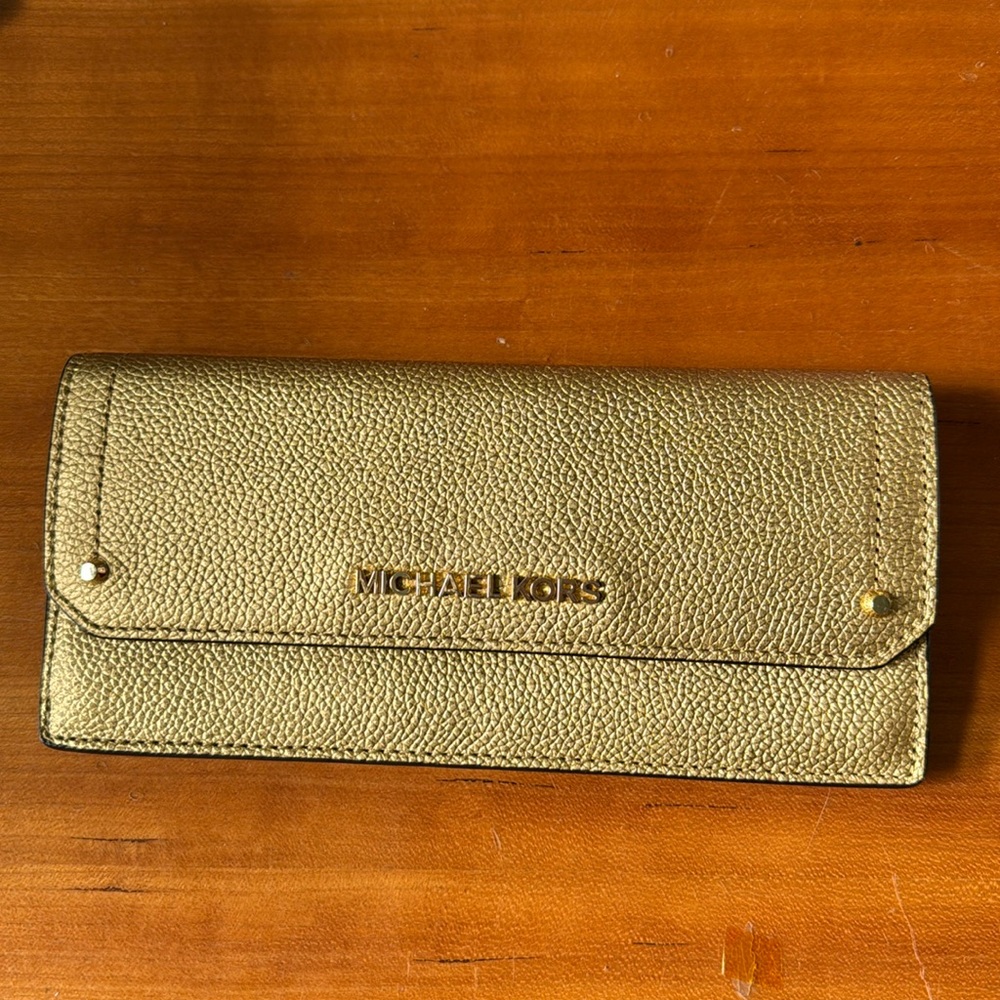 Gold toned Michael Kors wallet Hayes collection NWOT. Retails for $128.00